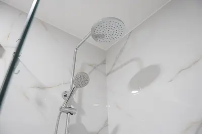 a shower with a shower head in a bathroom at GuestReady - Urkunina apartment in Porto