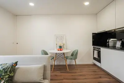 a kitchen with a table and chairs in a room at GuestReady - Urkunina apartment in Porto