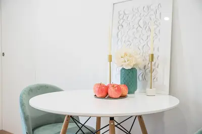 a white table with two apples on top of it at GuestReady - Urkunina apartment in Porto