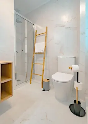 a bathroom with a toilet and a walk in shower at The Cale - Porto, Firmeza 2 in Porto
