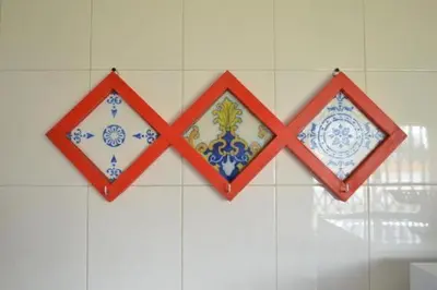 three decorative tiles hanging on a wall at T1 near El Corte Inglés in Vila Nova de Gaia