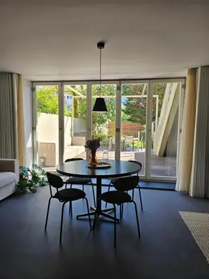 a dining room with a table and chairs in a living room at Lima Junior Residences in Porto