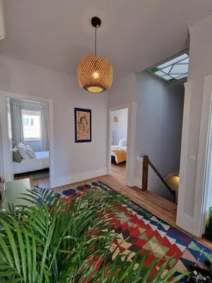 a living room with a chandelier and a rug at Lima Junior Residences in Porto