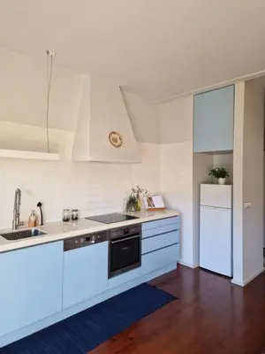 a white kitchen with a sink and a dishwasher at Lima Junior Residences in Porto