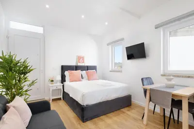 a white bedroom with a bed and a desk at Riverside Studio By Luís Bridge, WOW & Half Rabbit in Vila Nova de Gaia