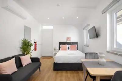 a living room with a bed and a couch at Riverside Studio By Luís Bridge, WOW & Half Rabbit in Vila Nova de Gaia