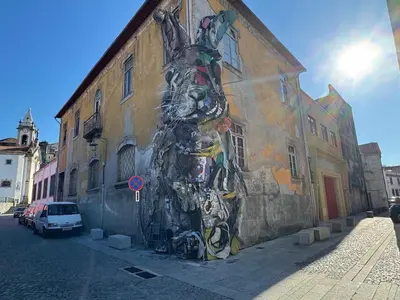a painting of a person on the side of a building at Cozy Studio 2 min walk to Douro River with AC in Vila Nova de Gaia
