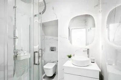 a white bathroom with a sink and a shower at Cozy Studio 2 min walk to Douro River with AC in Vila Nova de Gaia
