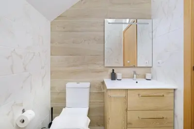 a bathroom with a toilet and a sink at Sunny House with Patio, Walk to Attractions in Vila Nova de Gaia