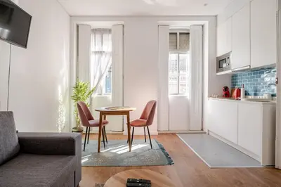 a living room with a table and chairs and a kitchen at 2-Studio House Steps from Best Attractions of Porto in Vila Nova de Gaia