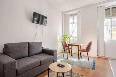 a living room with a couch and a table at 2-Studio House Steps from Best Attractions of Porto in Vila Nova de Gaia