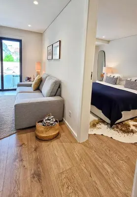 a living room with a couch and a bed at Central Apartment with parking/terrace in Porto