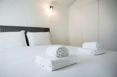 two towels on a white bed in a room at GuestReady - Vera Cruz Apartments in Porto