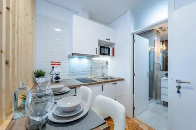 a kitchen with a table and chairs in a room at New Alegria in Town 2 in Porto