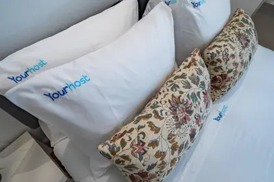 a bed with two pillows with the word yourself on it at New Alegria in Town 2 in Porto