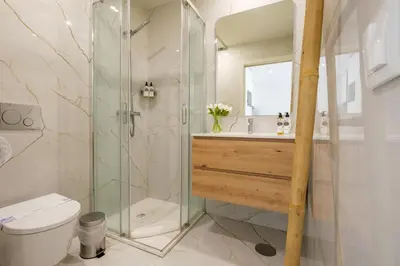 a bathroom with a shower and a toilet and a sink at Luxury Style 7 with AC Downtown Porto near Metro in Porto