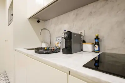 a kitchen counter with a sink and a microwave at Luxury Style 6 with AC Downtown Porto near Metro in Porto