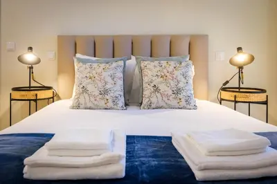 a bedroom with a bed with towels on it at Luxury Style 6 with AC Downtown Porto near Metro in Porto