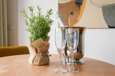 a table with two glasses and a bottle of wine at Cedofeita Sunshine Luxury Apartment Downtown Porto in Porto