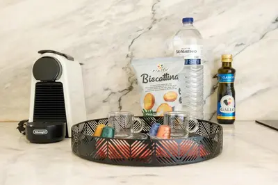 a black basket with cups and a bottle of water at Cedofeita Sunshine Luxury Apartment Downtown Porto in Porto