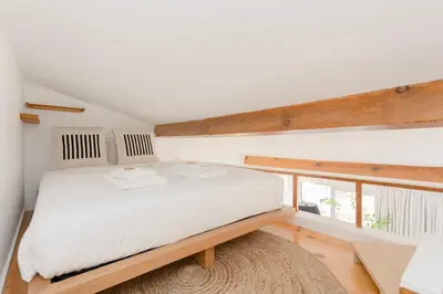 a bedroom with a white bed and a large window at Liiiving in Porto - Mezzanine Delight Balcony in Porto