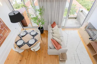 an overhead view of a living room with a table and chairs at Liiiving in Porto - Mezzanine Delight Balcony in Porto