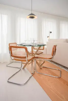 a dining room with a glass table and two chairs at Liiiving in Porto - Modern & Glam Apartment J in Porto