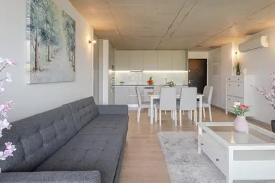 a living room with a couch and a table at HostWise - Modern Flat w/ Balcony, Garage & Pool in Vila Nova de Gaia