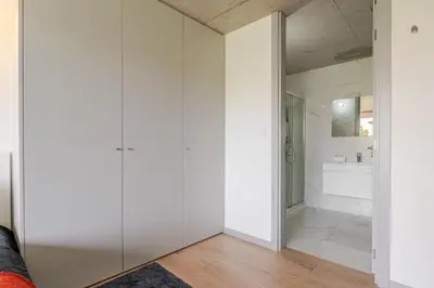a white bathroom with a sink and a mirror at HostWise - Modern Flat w/ Balcony, Garage & Pool in Vila Nova de Gaia