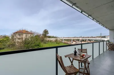 a view from the balcony of a house with a table and chairs at HostWise - Modern Flat w/ Balcony, Garage & Pool in Vila Nova de Gaia
