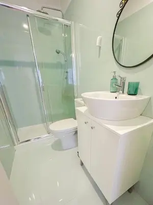 a bathroom with a sink and a shower and a toilet at Bonfim - Porto River in Porto