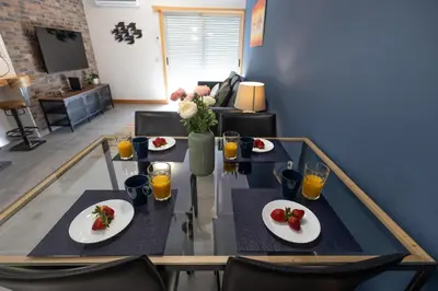a dining room table with plates of food and orange juice at Porto Cathedral III in Porto