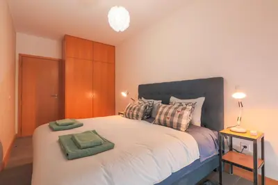 a bedroom with a large bed with two pillows at Porto Cathedral III in Porto