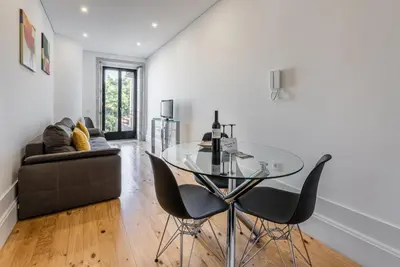 a dining room with a glass table and chairs at GuestReady - Rose Apartment in Porto