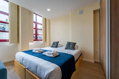 a bedroom with a bed with towels on it at Close to Everything Your Oporto Blue PRM 2F in Porto