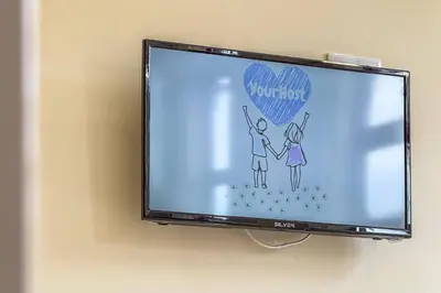 a flat screen tv with a picture of a couple at Close to Everything Your Oporto Blue PRM 2F in Porto