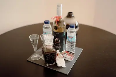 a table with a remote control and a vase of flowers at Almada 516 by Best2Stay in Porto