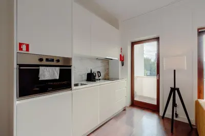 a kitchen with white cabinets and a stove at Almada 516 by Best2Stay in Porto