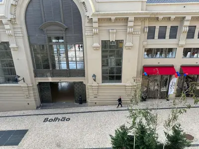 a man walks in front of a building at Apartment in Market Bolhão- W Views 2F in Porto