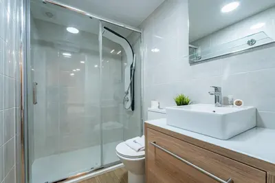 a white kitchen with white cabinets and a sink at Close to Everything Your Oporto Terrace PRM 1T in Porto