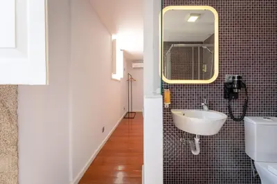 a bathroom with a sink and a mirror at Feel Porto Ribeira Vintage Duplex in Porto