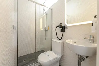 a bathroom with a toilet and a sink and a shower at Feel Porto Ribeira Vintage Duplex in Porto