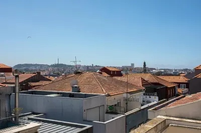 a view of roofs of buildings in a city at Liiiving in Porto - Downtown Balcony Apartment in Porto