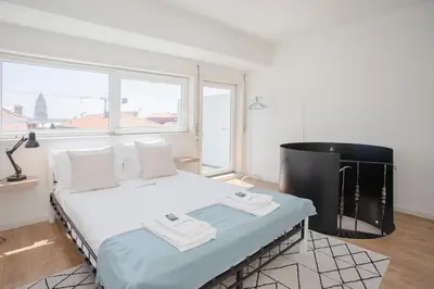 a bedroom with a bed with two towels on it at Liiiving in Porto - Downtown Balcony Apartment in Porto