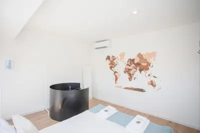 a room with a map of the world on the wall at Liiiving in Porto - Downtown Balcony Apartment in Porto