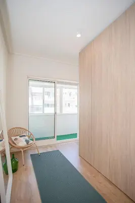 a room with a wooden partition and a chair and a rug at Liiiving in Porto - Downtown Balcony Apartment in Porto
