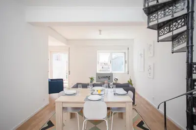 a dining room and living room with a table and chairs at Liiiving in Porto - Downtown Balcony Apartment in Porto