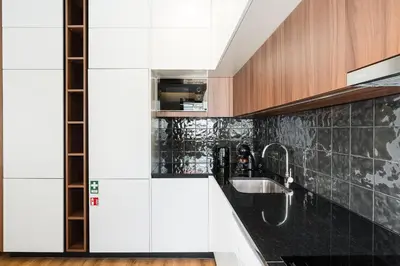a kitchen with a sink and black and white tiles at GuestReady – The Mythic Apartments in Porto