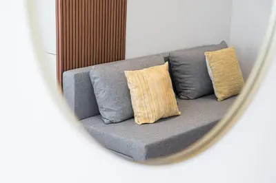 a reflection of a couch in a mirror at GuestReady – The Mythic Apartments in Porto