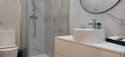 a white bathroom with a sink and a shower at Barramares Concept Lifestyle Oporto City Center in Porto